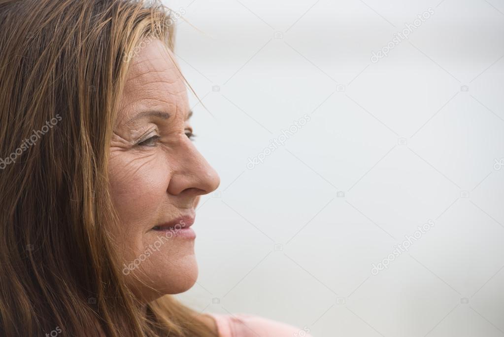 Profile portrait happy relaxed mature woman