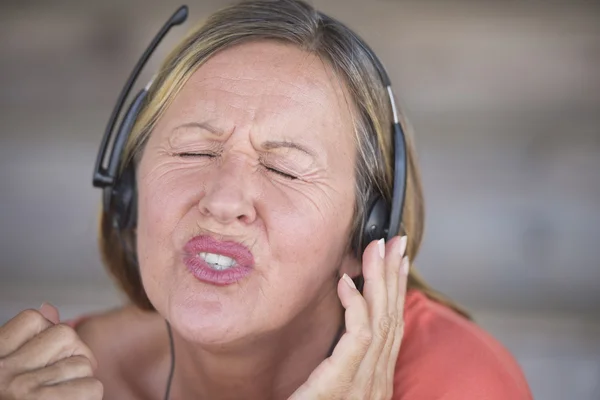 Kobieta z słuchawki, śpiewa do muzyki — Zdjęcie stockowe