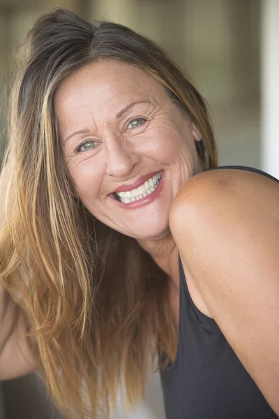 Attractive mature woman playing with long hair — Stock Photo, Image