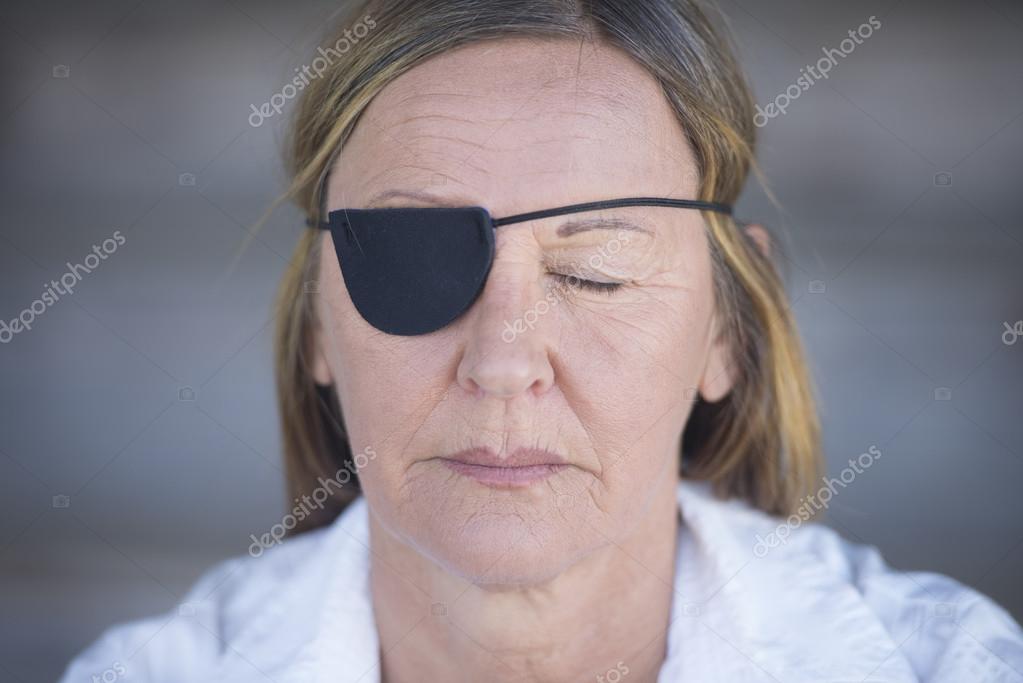 Mature woman with eye patch portrait Stock Photo by ©roboriginal 70862335
