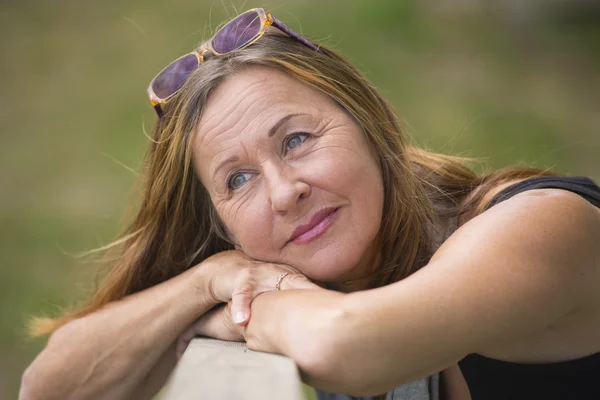 Attractive relaxed mature woman daydreaming — Stock Photo, Image