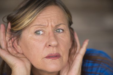Woman listening worried to sound and noises clipart