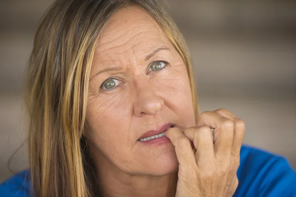 Insecure woman biting finger nails — Stock Photo, Image