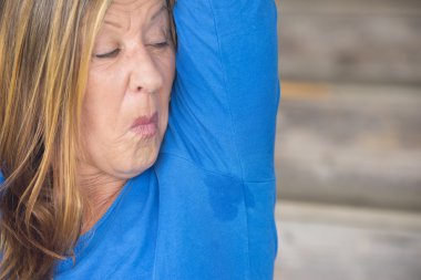 Embarassed Woman sweating under arm clipart