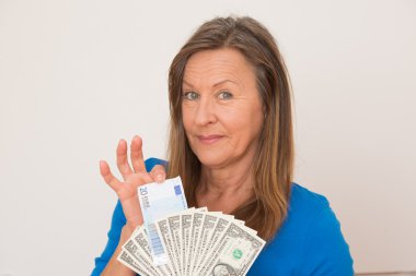 Joyful woman with us dollar and euro currency notes