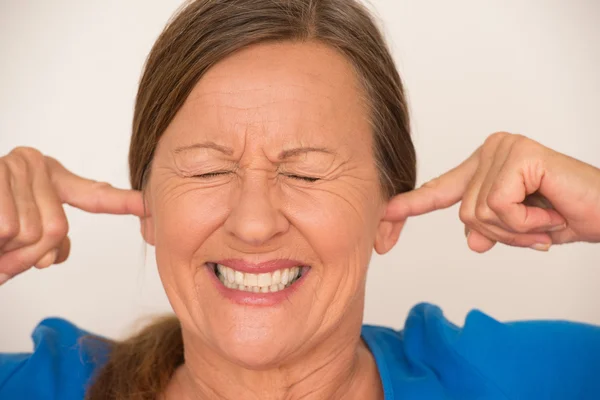 Noise Stressed woman covering ears — Stockfoto