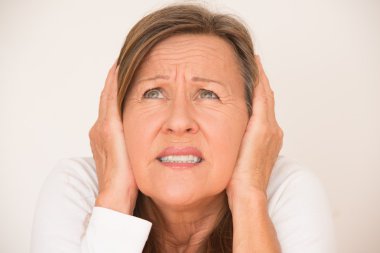 Scared anxious woman covering ears