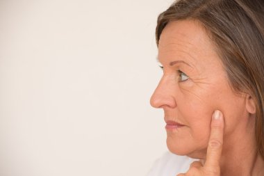 Serious portrait mature woman thinking