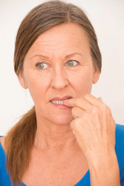 Nervous woman biting finger — Zdjęcie stockowe