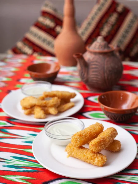 cheese sticks and chicken nuggets - fried cheese and breaded fried chicken served with a creamy sauce. Asian style