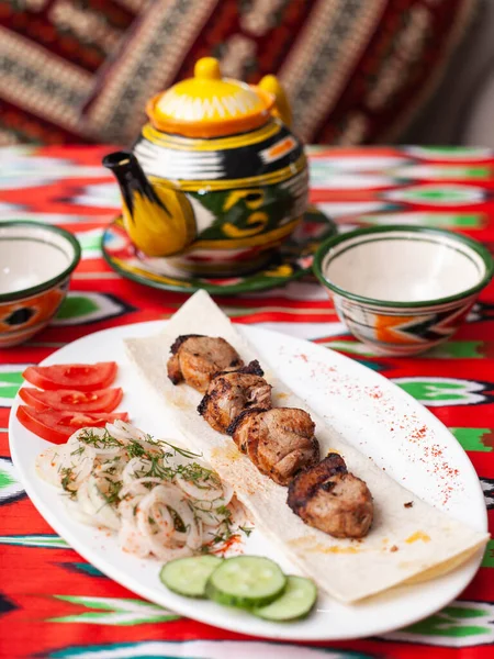 Kebab de pollo - pechuga de pollo a la parrilla.Se sirve con verduras, cebollas en escabeche, pan de lavash y salsa oriental — Foto de Stock