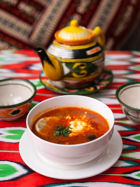 Solyanka. Meat soup made from meat, smoked meats, olives and lemon, served with sour cream. East style — Stock Image Solyanka. Meat soup made from meat, smoked meats, olives and lemon, served with sour cream. East style Royalty Free Stock Images