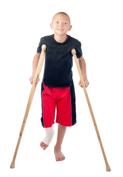 Boy with crutches Royalty Free Stock Images