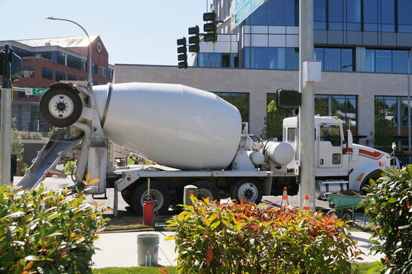 Mixer trucks in city traffic. A city in the USA. 