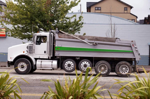 A large dump truck waiting to be loaded. Road works in the city center.