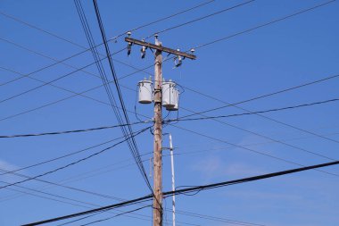 USA. Classic wooden pole with electrical installations.  Oil transformers. If mounted on a utility pole, they are called pole-mount transformers.