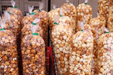 Popcorn stall at the stadium. Different types of popcorn: kettle, caramel, chocolate. 