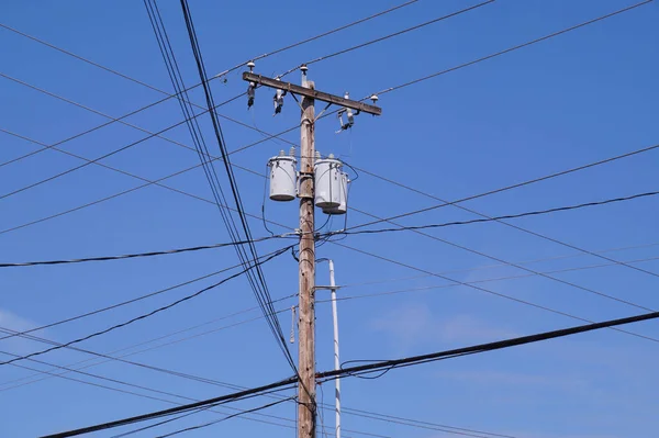 USA. Classic wooden pole with electrical installations.  Oil transformers. If mounted on a utility pole, they are called pole-mount transformers.