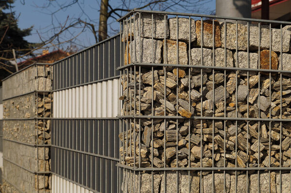 Gabions. An interesting example of fencing, metal baskets filled with different rock material.