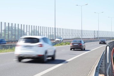 Noise barriers on the motorway. Barriers protect local residents from traffic noise. clipart