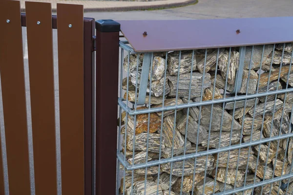 Gabion. Close-up of a detail of a fence built with stones placed in steel baskets.