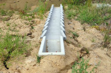 Otoyolun inşaatı. Yol yüzeyindeki fazla suyu boşaltmak için beton modüllerden oluşan bir sistem.