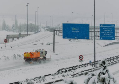 Snowplow at Highway A1 in Las Tablas, Madrid, Spain following winter storm Filomena clipart