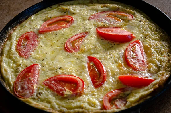 Dökme demir tavada patates ve domatesli Rustik omlet..