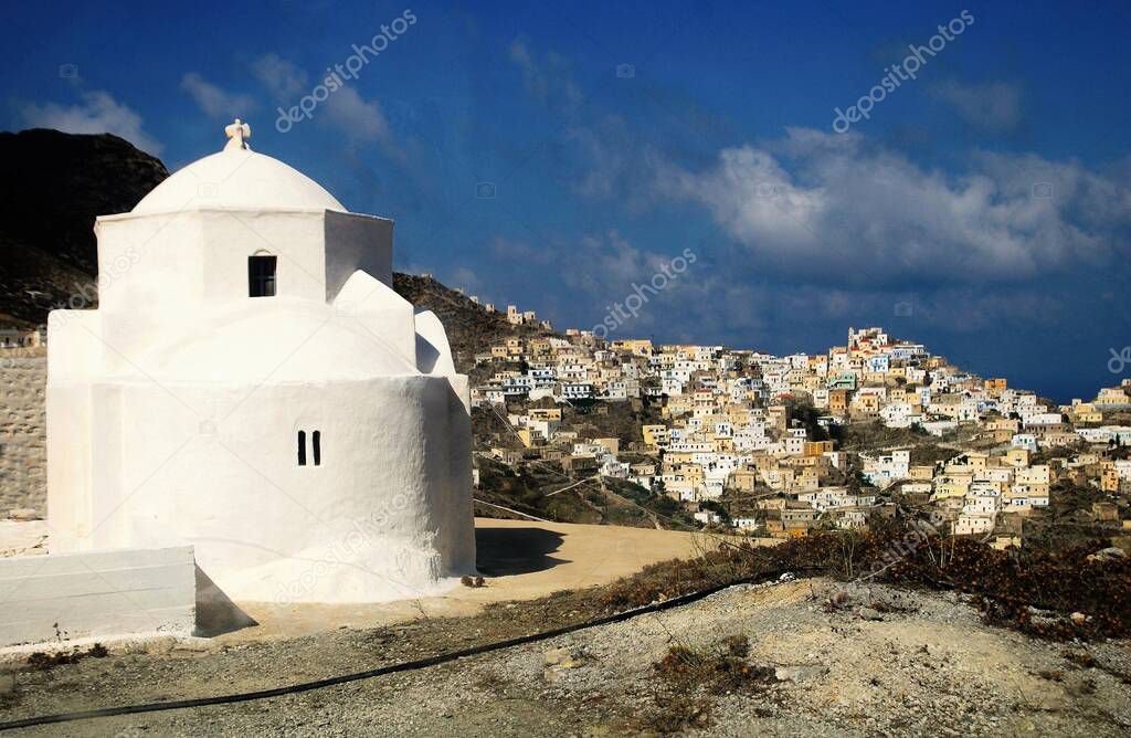 Greece, Karpathos island, Christian orthodox church with the village of Olympos in the background.