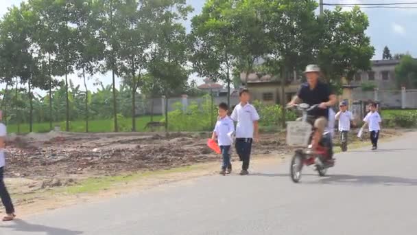 Studenten wandelen en fietsen op de weg — Stockvideo