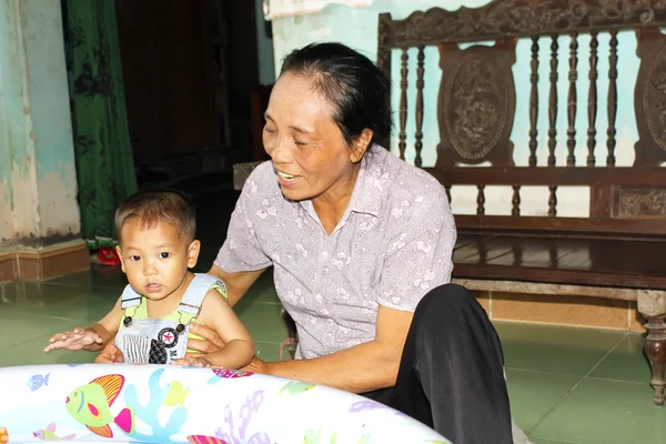 Old woman playing with grandson — Stock Photo, Image