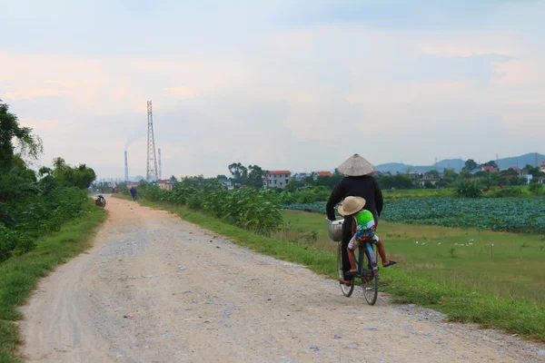 Asian woman riding a bicycle on the road — Stock Photo, Image