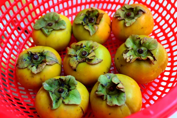 The persimmons in the basket — Stock Photo, Image