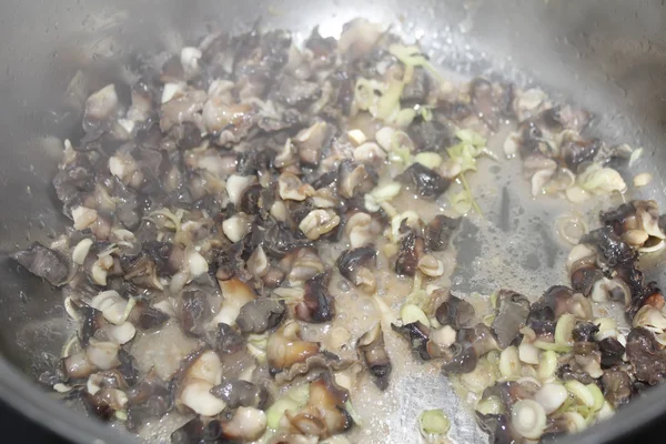 Closeup of eating the fried snails with stalks lemon grass — Stock Photo, Image