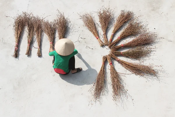 Girl drying brooms — Stock Photo, Image