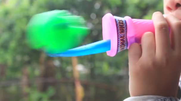 Haiduong, Vietnam, March, 14, 2015, boy blow the trumpet toy — Stock Video