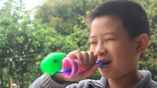 Haiduong, Vietnam, March, 14, 2015, boy blow the trumpet toy — Stock Video