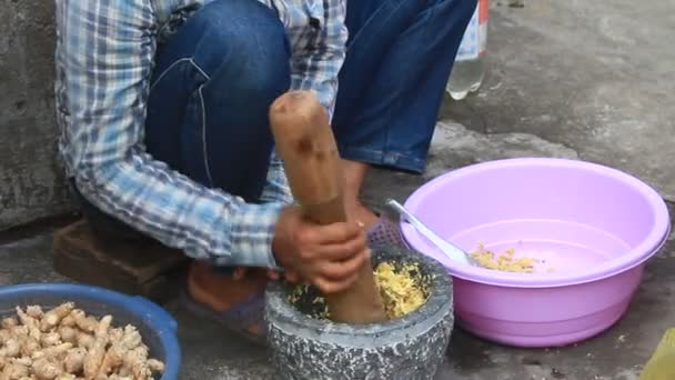 Haiduong, Vietnam, 24. Dezember 2014: Frau schlägt Ingwer mit Mörserstein — Stockvideo