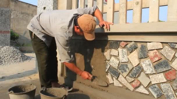 HAI DUONG, VIETNAM, OCTOBER, 12: worker install stone wall surface with cement on October, 12, 2014 in Hai Duong, Vietnam — Stock Video