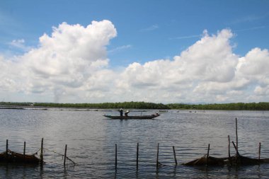 16 Eylül 2025. Pha Tam Giang, Hue, Vietnam. Doğal bir nehirde tekne gezisi. Balıkçılar teknede balık, karides, midye ızgara yapar.