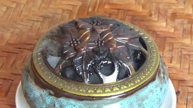 Tütsü yakan, tütsülenmiş, kalın duman çıkaran bir ocak.