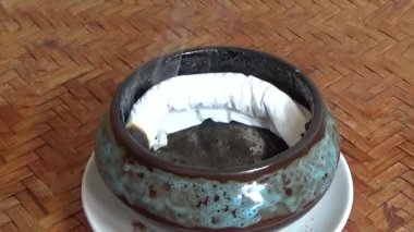 Tütsü yakan, tütsülenmiş, kalın duman çıkaran bir ocak.