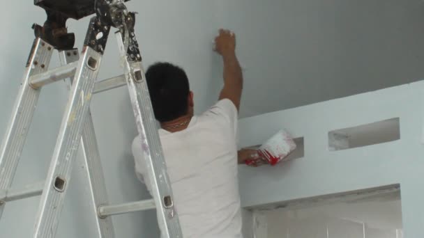 Asian man painting house — Stock Video