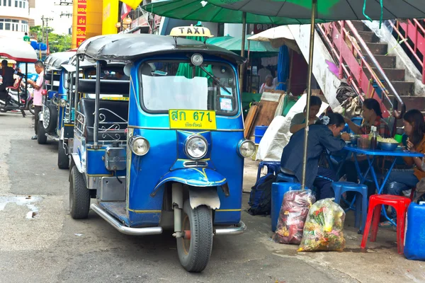 Famous three-wheeled taxi (tuktuk) parking at the street — Stock Photo, Image