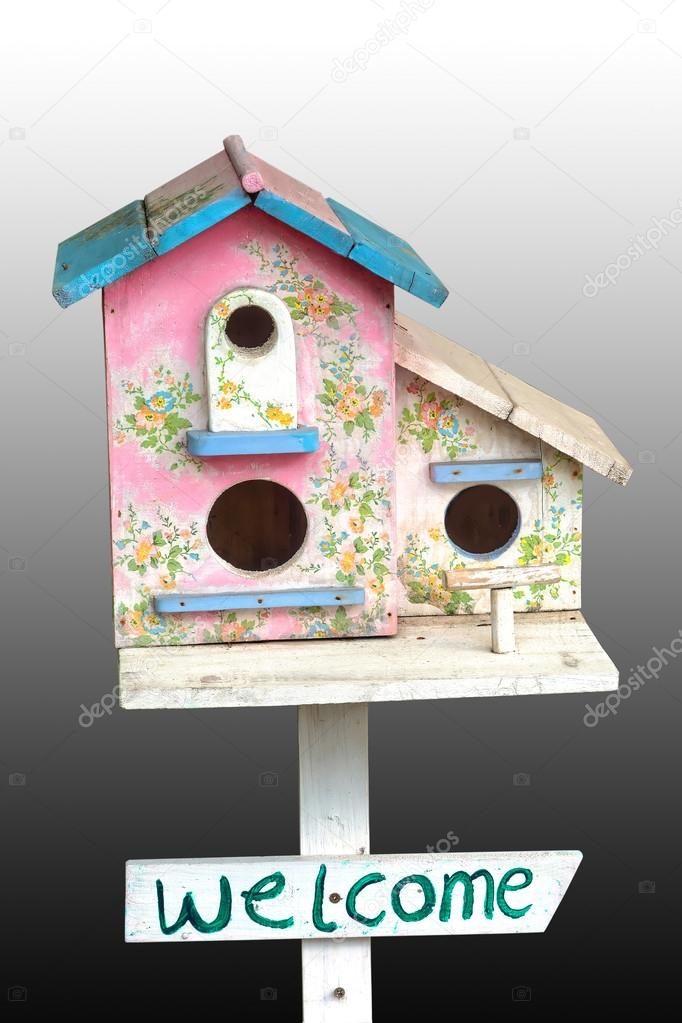 Colorful wooden bird house with hole on white background