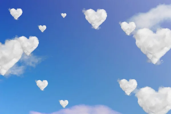 Clouds shape hearts on blue sky. Valentine\'s day background.