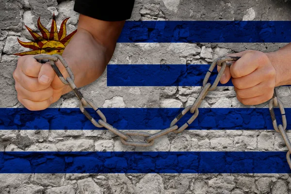 male hands breaking the iron chain, symbol of tyranny, protest against the background of the state flag of Uruguay, the concept of political repression, arrest, crime, civil rights, freedom