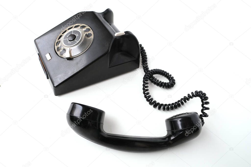 vintage black telephone set with dialing dial in retro style on white background, concept of old communication technologies, call waiting, call center
