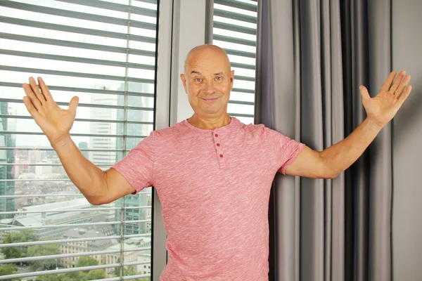 Middle Aged Bald Man Pink Shirt Stands Window Office Emotionally — Stock Photo, Image
