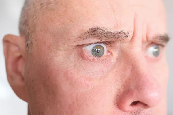 60代の白人男性の灰色の目の近さと正面図 強いしわ 顔の明るい感情 男性のスキンケアコンセプト — ストック写真